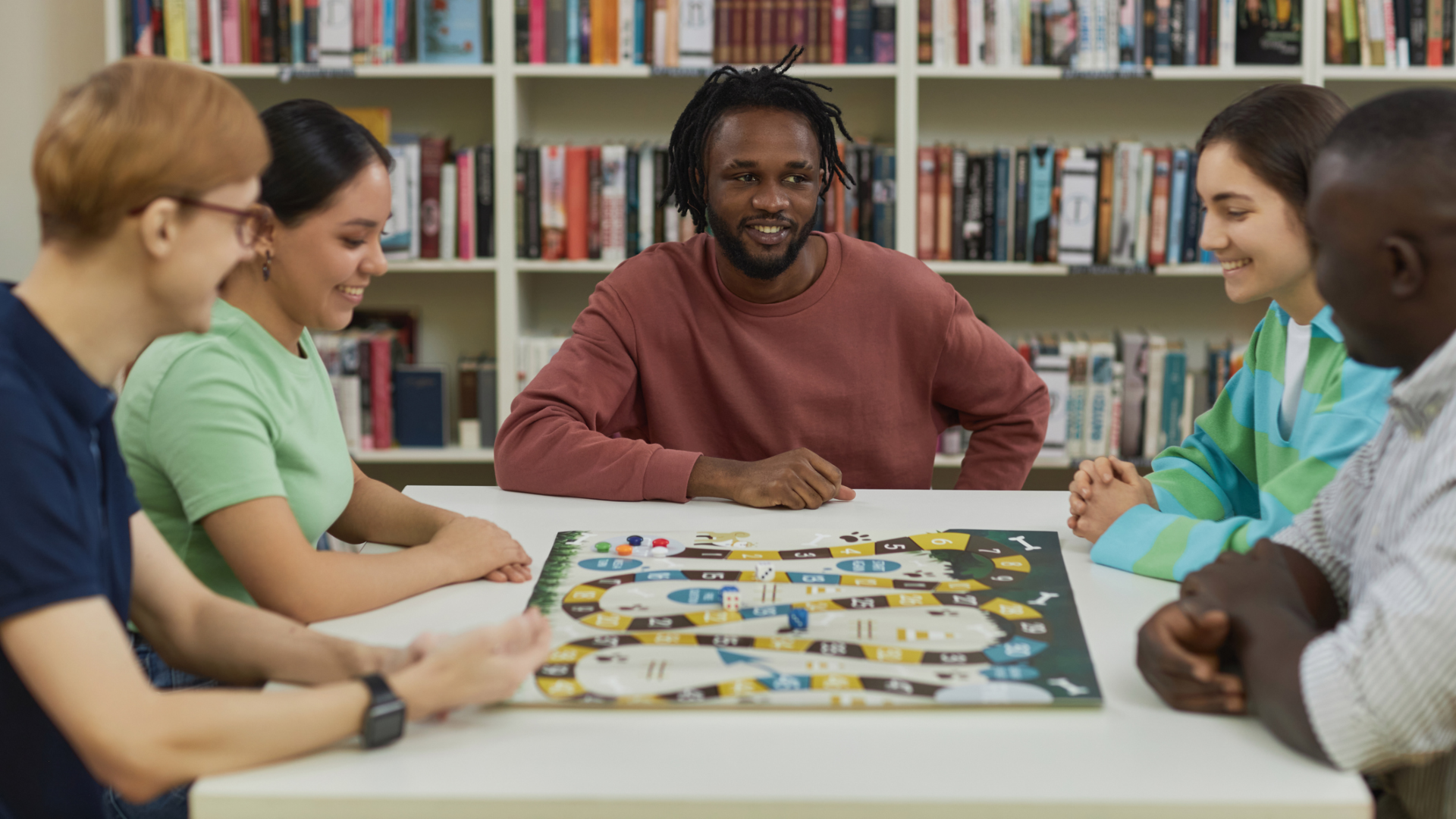 5 friends playing a board game