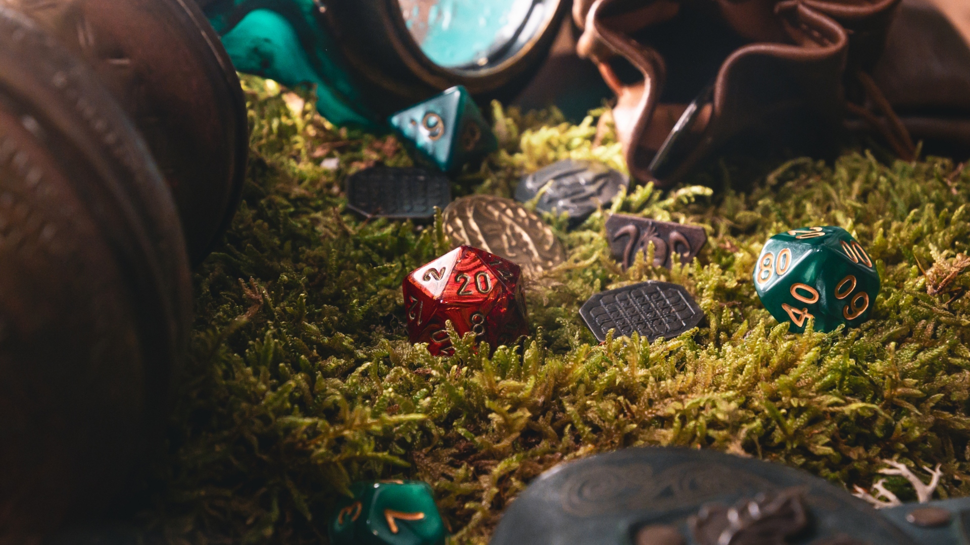 Assorted polyhedral dice and fantasy tokens scattered on moss, creating an immersive tabletop roleplaying game setting.